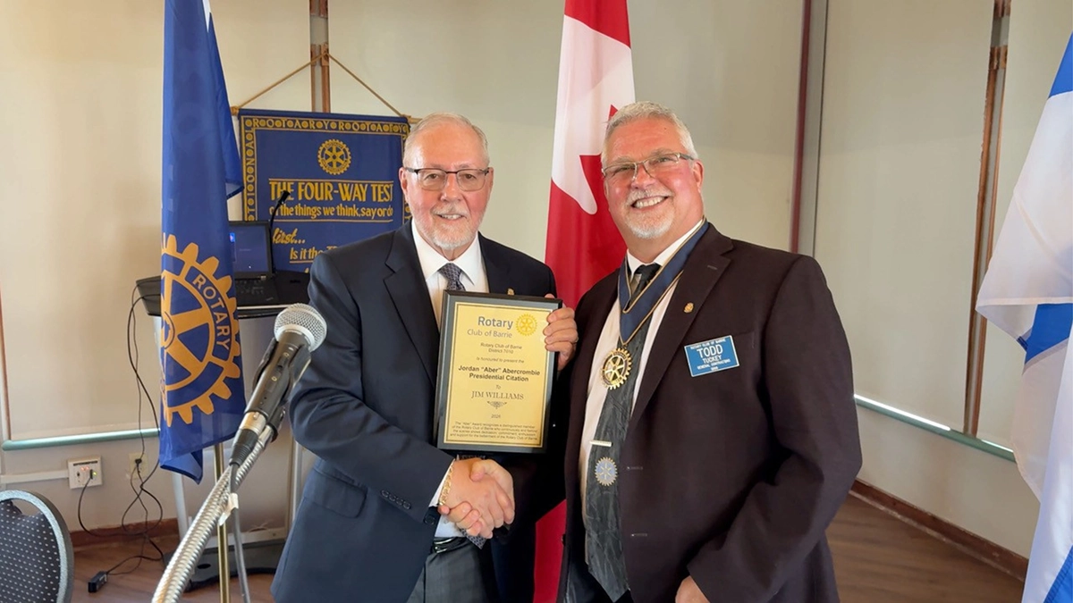 Jim Williams receiving the 2026 Aber Award from President Todd Tuckey
