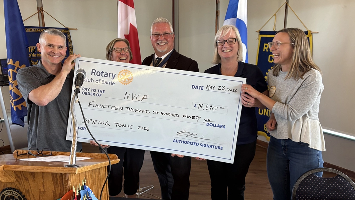 Darren Robinson presenting a cheque from Spring Tonic to Kyra Howes of the NVCA at the Rotary Club of Barrie meeting